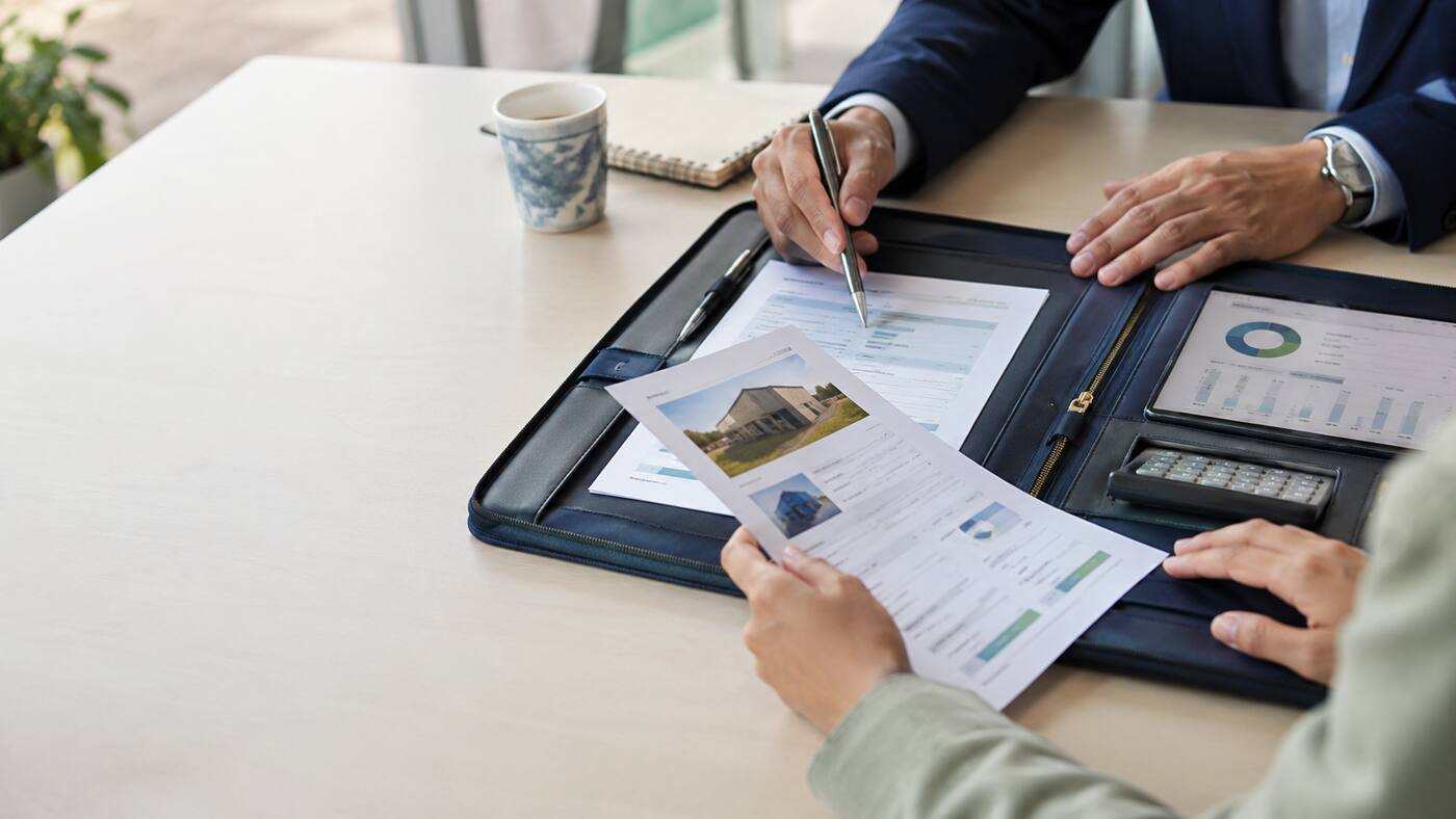 A business owner and advisor reviewing an organized lending file